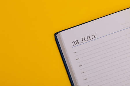 Notepad or diary with the exact date on a yellow background. Calendar for July 29 - summer time. Space for text.の写真素材