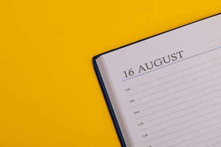 Notepad or diary with the exact date on a yellow background. Calendar for August 28 - summer time. Space for text.の写真素材