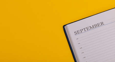 Notepad or diary on a yellow background. Calendar for November. Fall time. Space for text, long sizeの写真素材