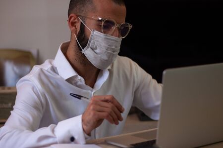 Man With Face Mask Working Home Office Start up Ideas Conceptの写真素材