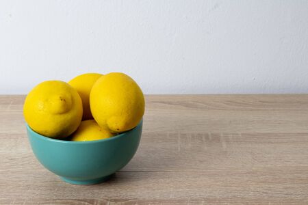 Plate with lemons on the wooden tableの写真素材