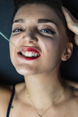 Portrait of girl playing with chewing gumの写真素材