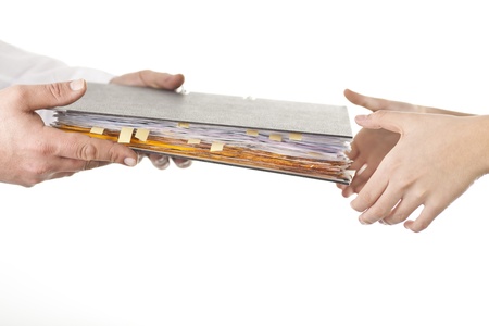 Male give file folder of paperwork to another personの写真素材