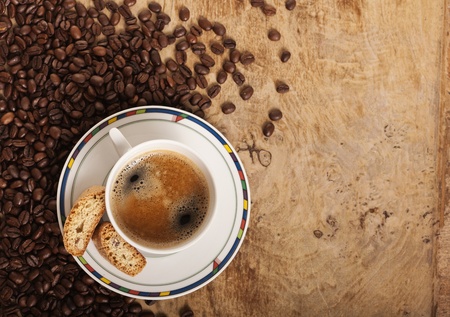Coffe cup over coffee beansの写真素材