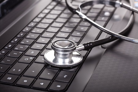 Close-up of stethoscope on laptop keyboard