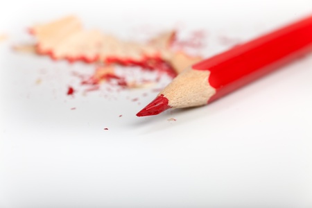 red pen with pencil shavings in the backgroundの写真素材