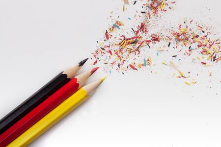 pens colored as german flag with pencil shavings bursting out