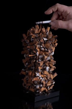 Ashtray full of smoked cigarettesの写真素材