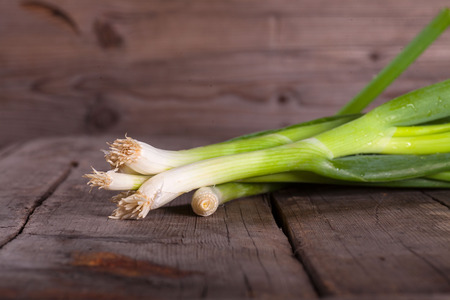 Green Onion on wooden tableの写真素材