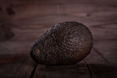 brown avocado on wooden tableの写真素材