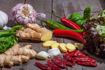 Ginger slices surrounded by assorted vegetablesの写真素材