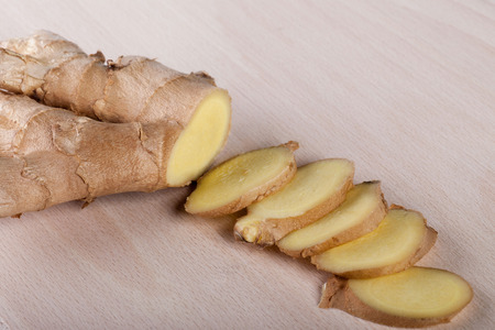 Ginger slices on wooden boardの写真素材