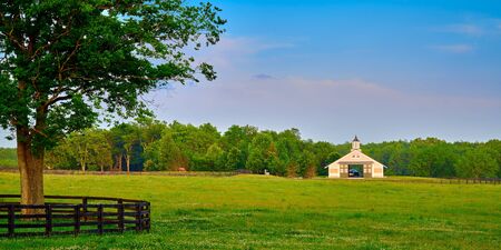Kentucky horse barn with field in the foreground.の写真素材