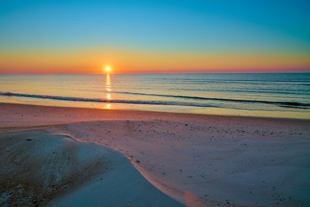 Sunrise over the Gulf of America at St. George Island Florida.の写真素材