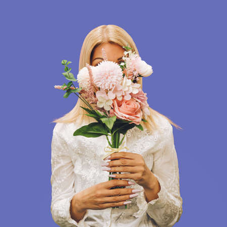 A blonde girl holding a romantic bouquet of pastel flowers. Fashionable composition, white lace, and delicate sophisticated pastel tones. Concept of engagement and marriage. Spring sophisticated idea.の写真素材
