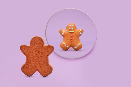 An interesting and cute concept. A biscuit figure with colorful details looks into a round mirror. Figure from the front and back. A concept that makes psychological sense. Pastel background.の写真素材