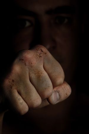 Injured fist of boxing fighter as a symbol of hazard