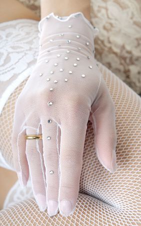 Close-up photo of the elegant hand in glove with wedding ringの写真素材