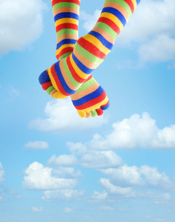 Photo of the legs in zebrine socks sitting in the skyの写真素材