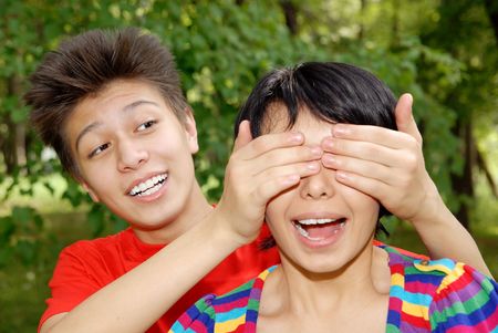 Couple of brother and sister playing outdoorsの写真素材