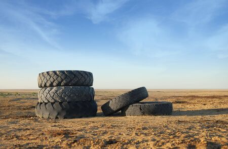 Photo of five old vehicle tires outdoorsの写真素材