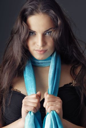 Front-view photo of the gorgeous model holding blue scarfの写真素材