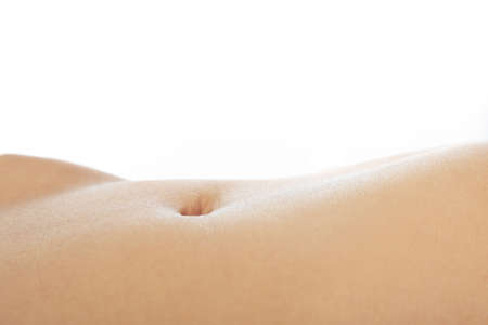 Female belly with soft skin on a white backgroundの写真素材
