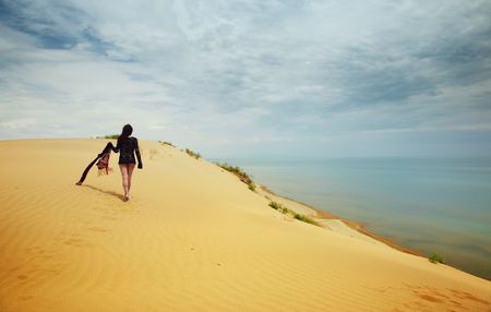 Lonely lady walking in the desert. Vibrant colorの写真素材