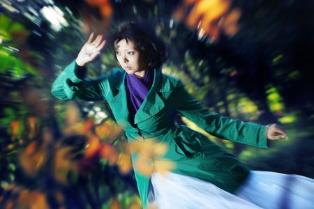 Lady outdoors in autumn. Photo with zoom-in blur effectの写真素材