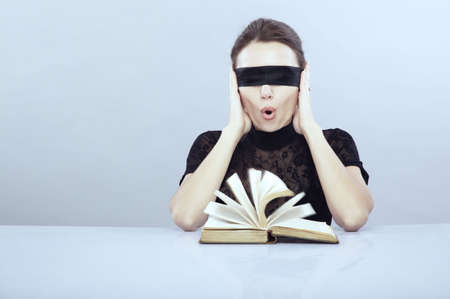 Turned book and screaming lady with closed ears and blindfoldの写真素材