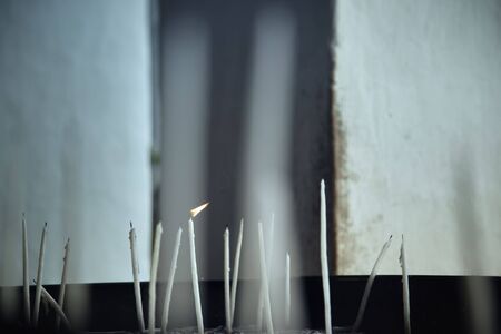 Religions candles in the Christian church. Close-up photo with shallow depth of field for natural viewの写真素材