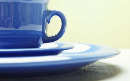 Blue teacup and plate on the table. Close-up photo with shallow depth of field for natural viewの写真素材