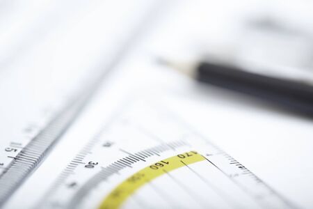 Drawing tools on a paper. Extremely close-up picture with shallow depth of field. Focus on rulerの写真素材