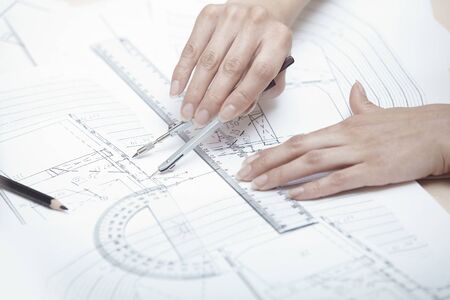 Hands of engineer working on a construction plan
