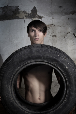 Man holding automobile tire.  の写真素材