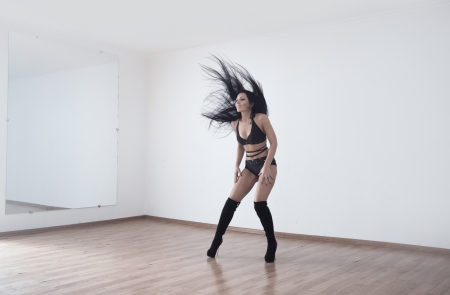 Woman performing seductive dance in ball roomの写真素材