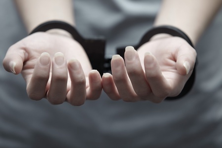 Human hands in handcuffs. Close-up horizontal viewの写真素材