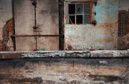 Abandoned factory with dirty doors and broken windowsの写真素材