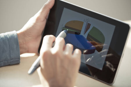 Human hands using tablet PC and sylus for diagram working. Diagram was created by me