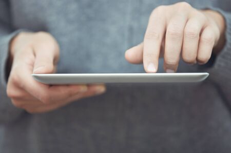 Woman with digital tablet surfing the web. Close-up viewの写真素材
