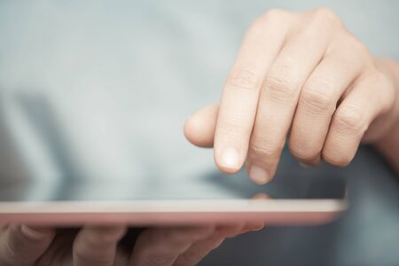 Human hands working with digital tabletの写真素材