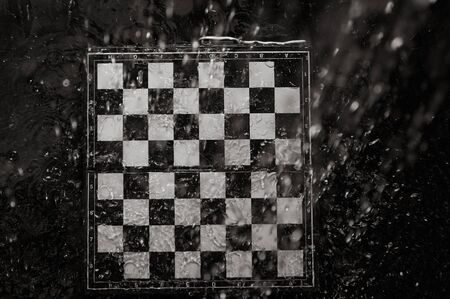 Chessboard under the rain. Close-up viewの写真素材