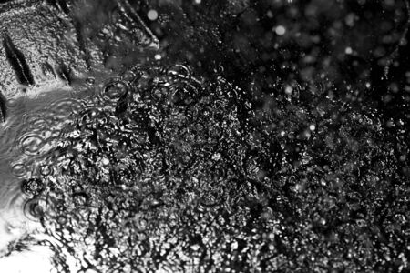 Top view on the ground with oil during rainの写真素材