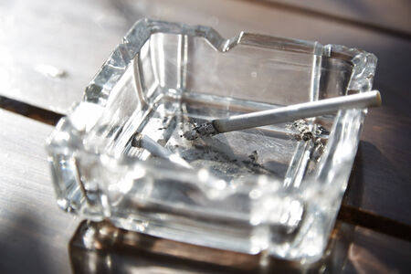Cigarette in glass ashtray. Horizontal photoの写真素材
