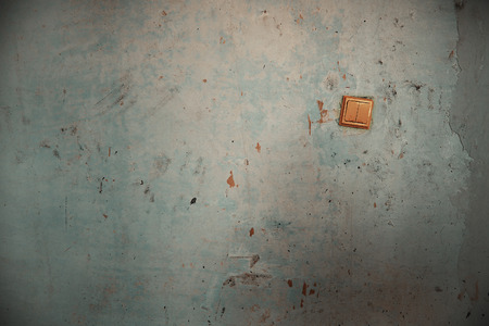 Old switch on the damaged wall. Horizontal photoの写真素材