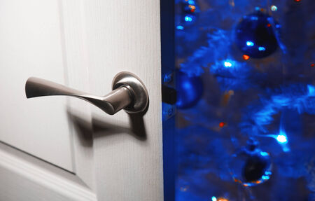 Opened door at home and Christmas tree on a backgroundの写真素材