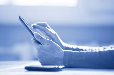 Hands of woman working with digital tablet