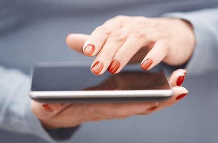 Hands of woman using digital tabletの写真素材