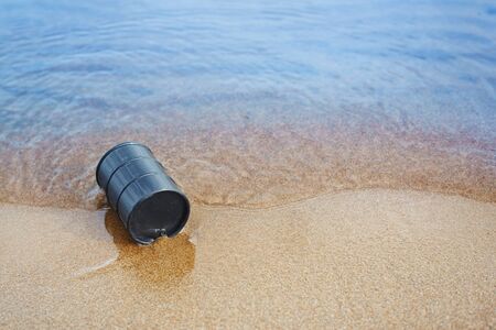 Oil barrel abandoned at the sea coastの写真素材