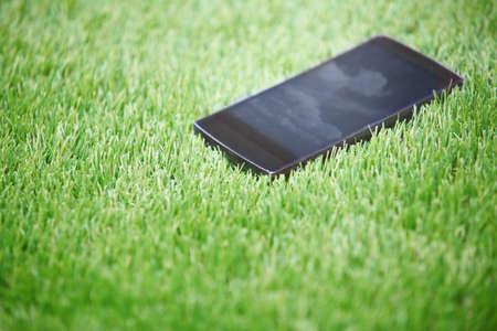 Smartphone lost in the grass. Horizontal photoの写真素材